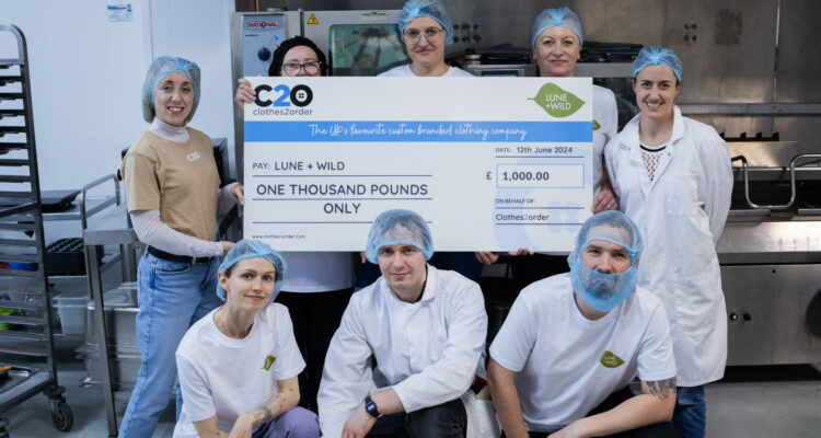 A group of people holding up a cheque